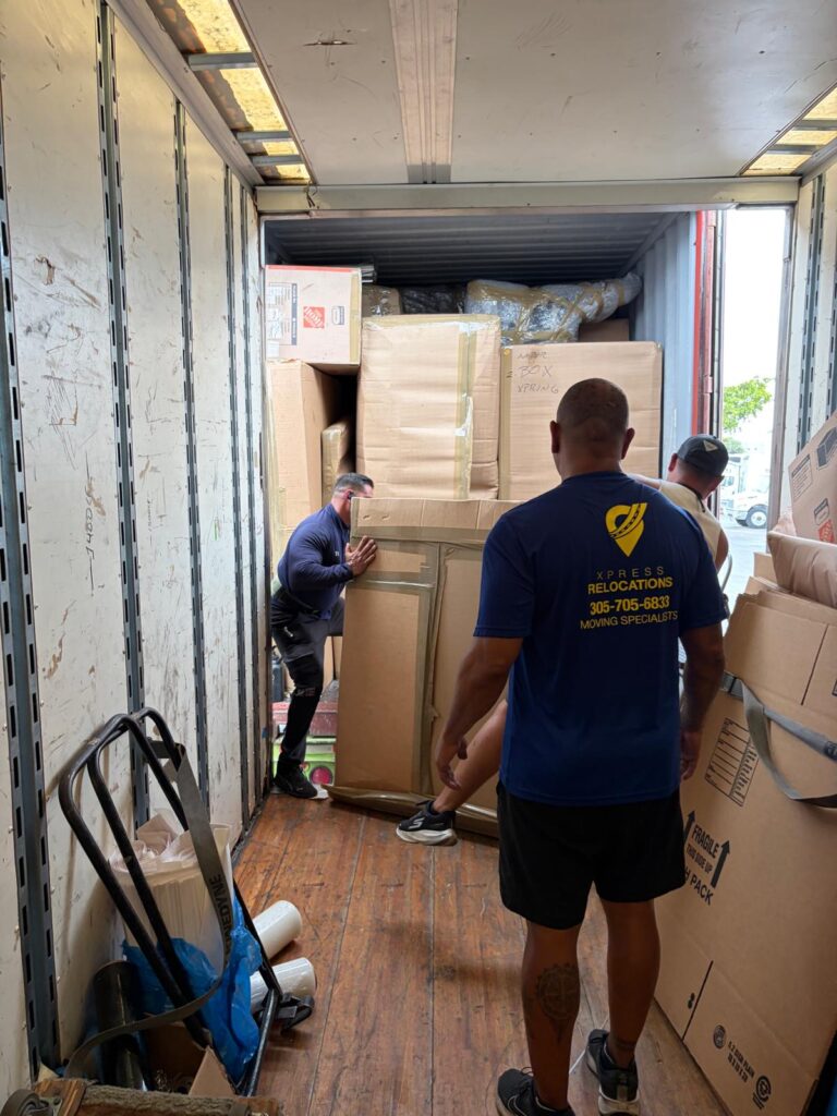 Xpress Relocations team loading LCL shared container shipment for international move from USA