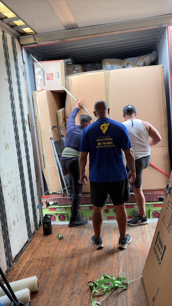 Xpress Relocations moving specialist loading international shipment inside shipping container in Miami